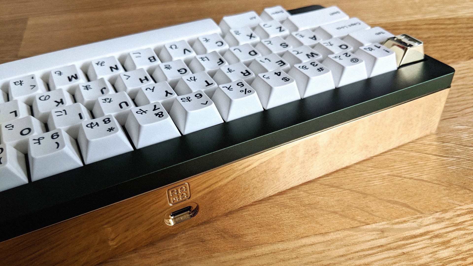 RAMA M-60a with PVD brass gold back weight on wooden desk