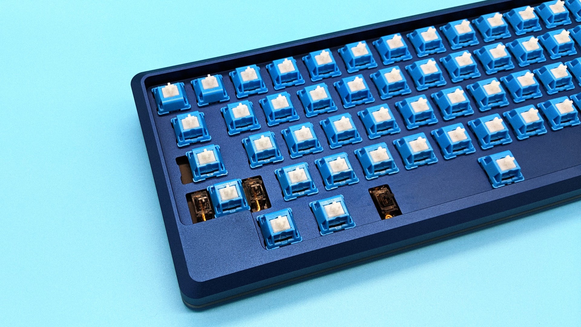 Tokyo60 v3 with no keycaps only switches on sky blue background