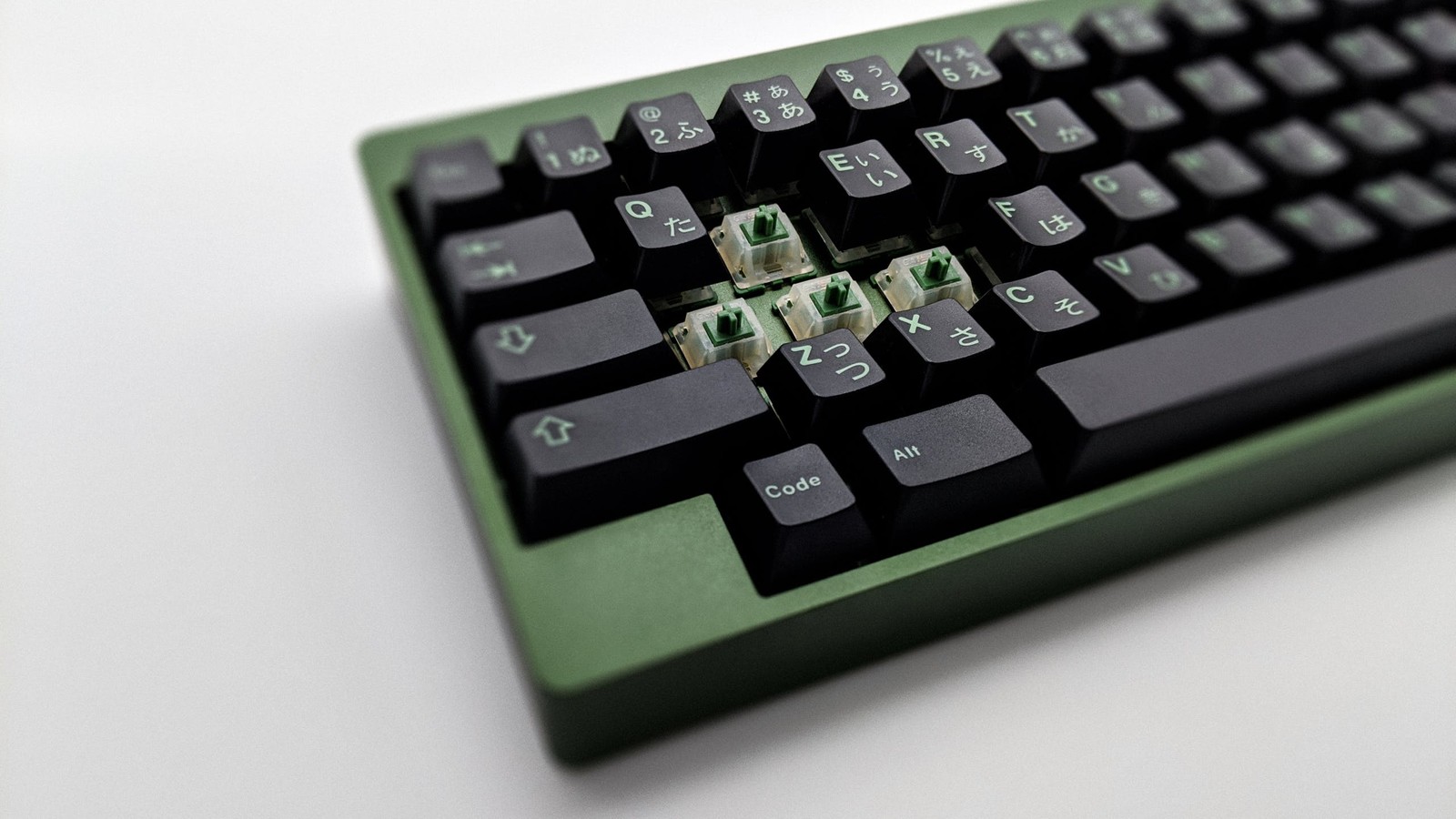 GMK Wasabi on green RAMA M60-a with four visible matcha switches on white background