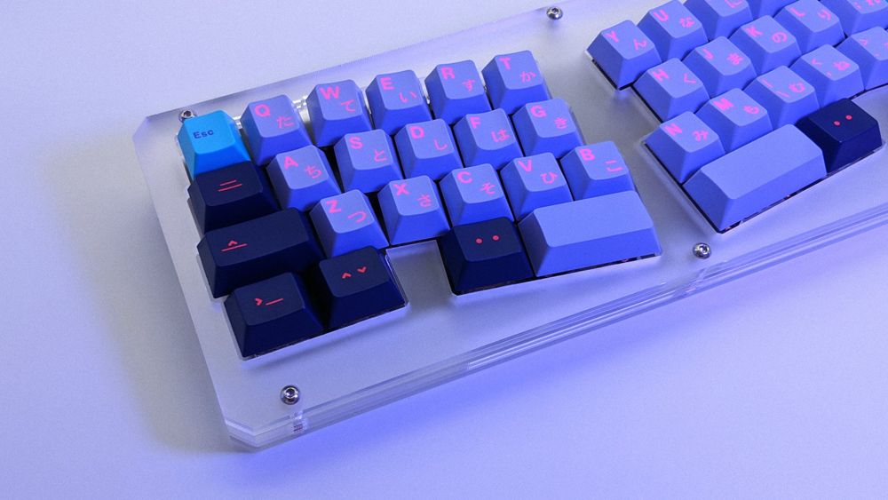 GMK Vaporwave and GMK Laser on Prime_E with a soft purple glow
